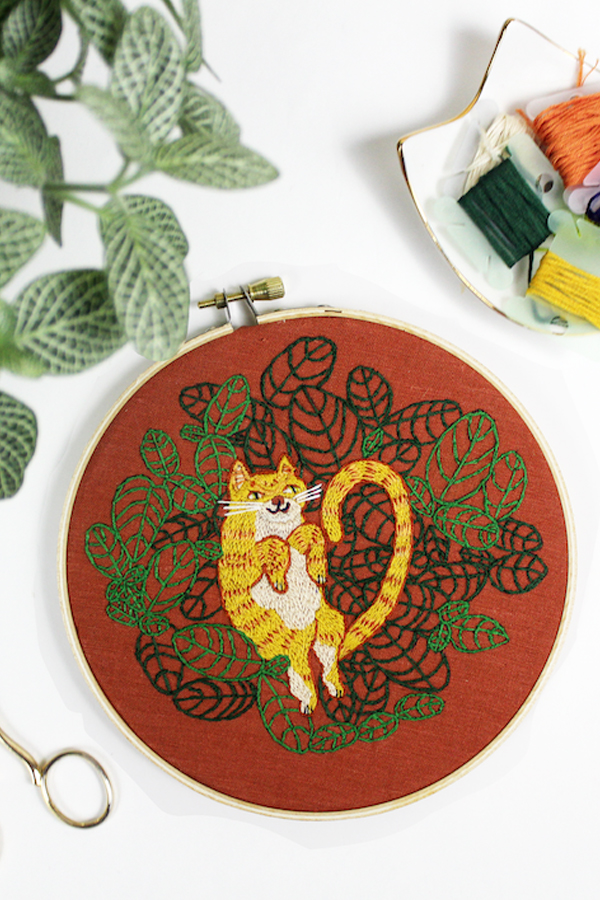 Hand embroidery of cats and plants