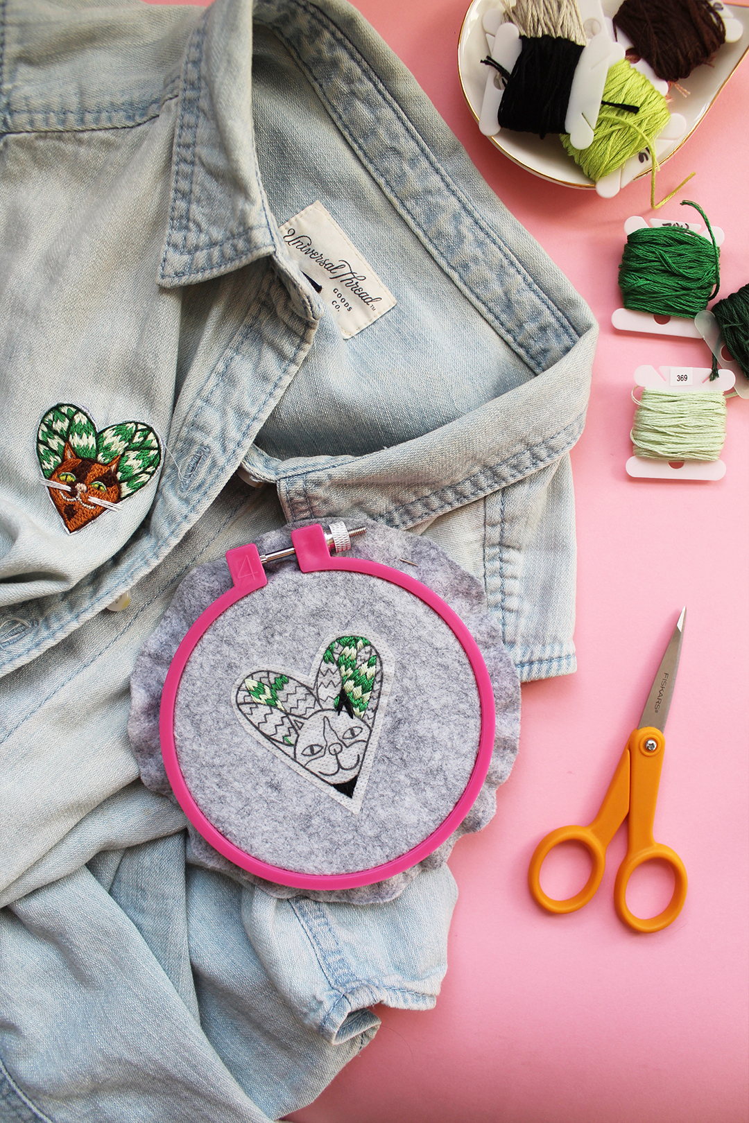 Free embroidery pattern of a cat surrounded by snake plant leaves