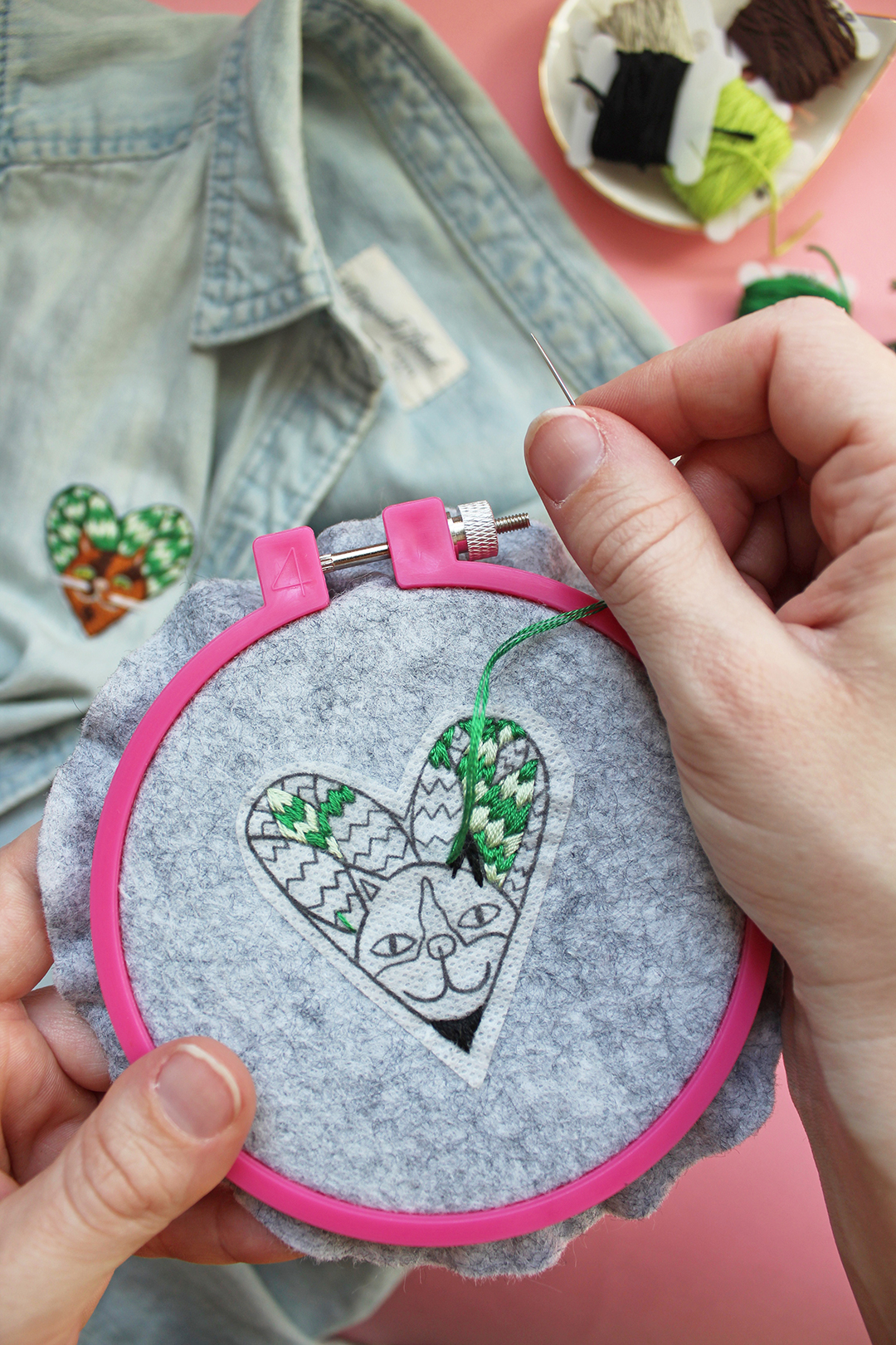 Free embroidery pattern of a cat surrounded by snake plant leaves