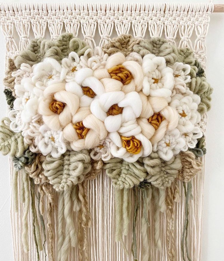 Modern macrame wall hanging with yarn flowers