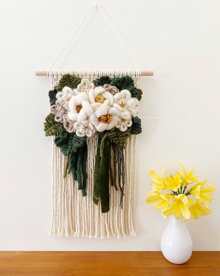 Modern macrame wall hanging with yarn flowers