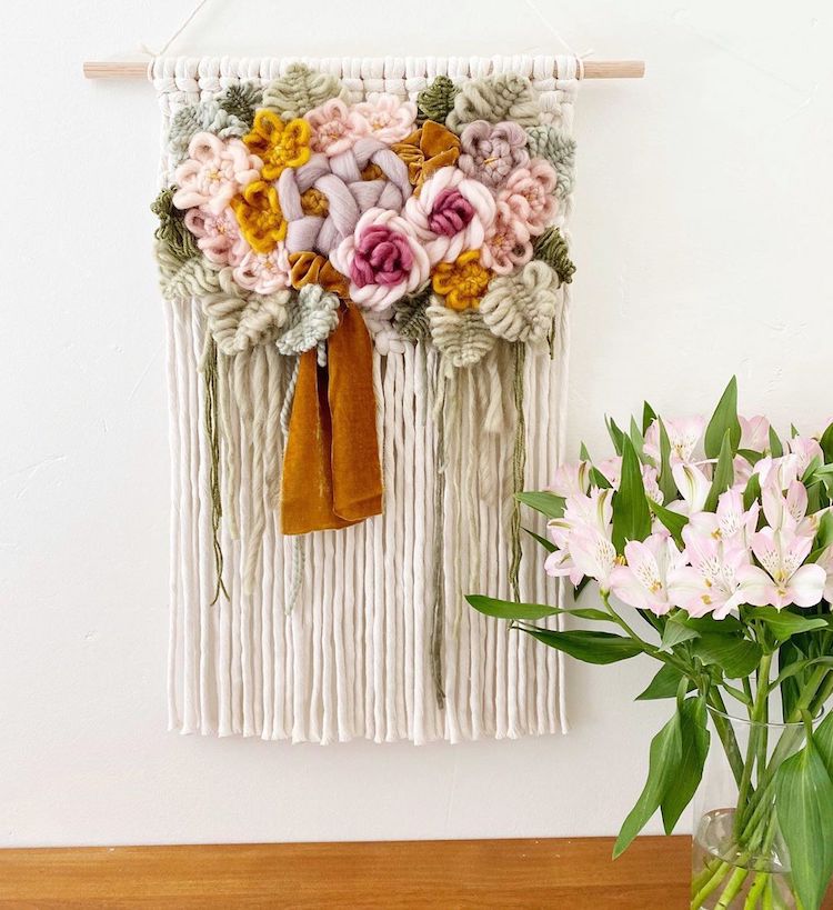 Modern macrame wall hanging with yarn flowers