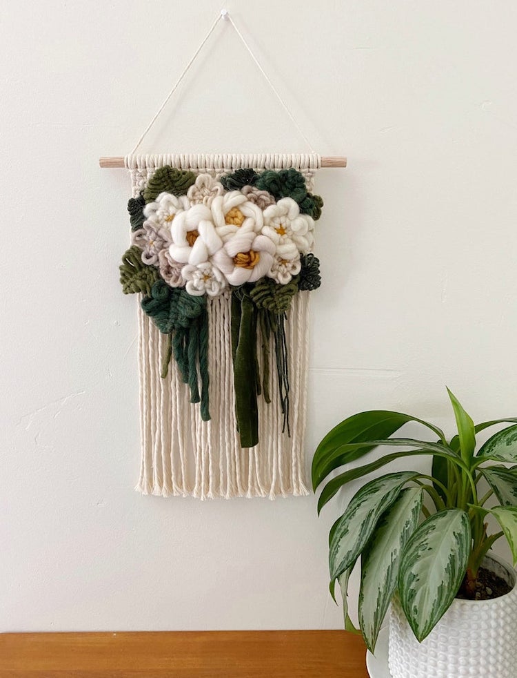 Modern macrame wall hanging with yarn flowers