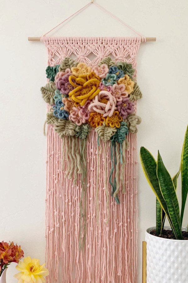 Modern macrame wall hanging with yarn flowers