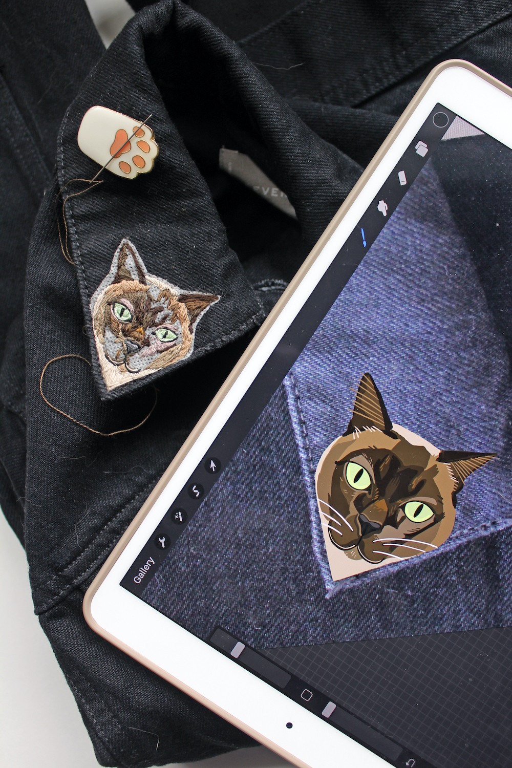 Cat embroidery accompanied by a digital sketch on an iPad