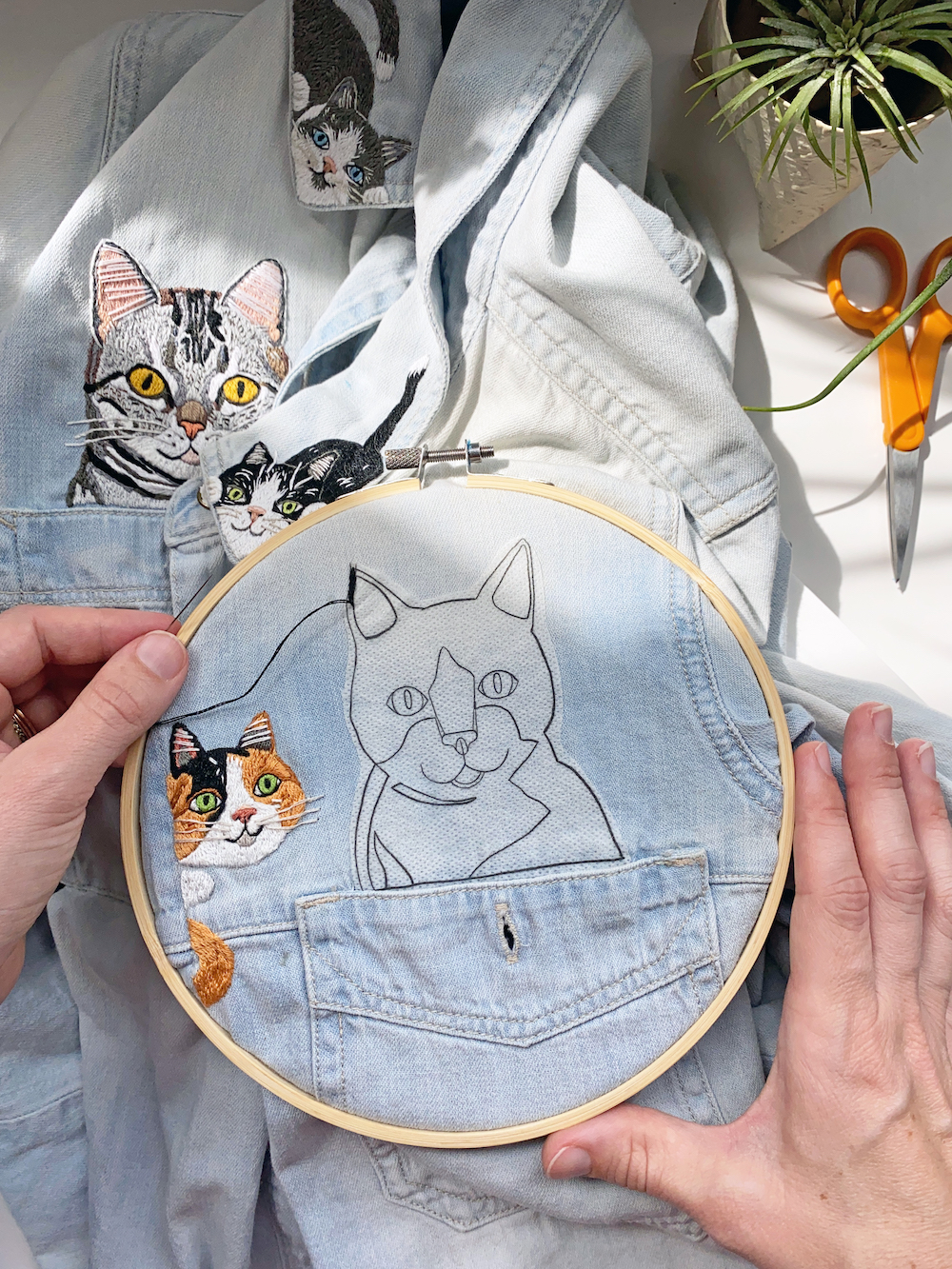 Stitching a cat above a shirt pocket