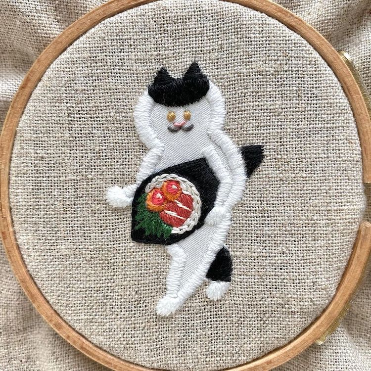 Embroidery of a Cat Carrying a Sushi