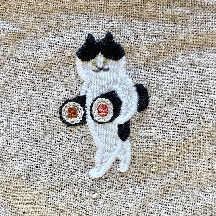 Embroidery of a Cat Carrying a Sushi