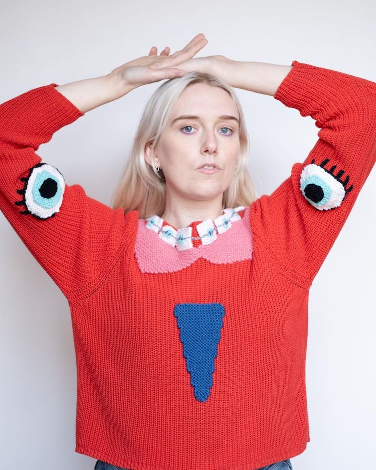 Knitted sweater with eyes and mouth on it by Ýrúrarí