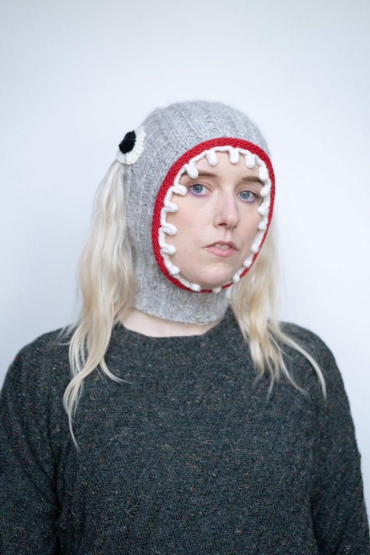Knitted balaclava with eyes and mouth on it by Ýrúrarí