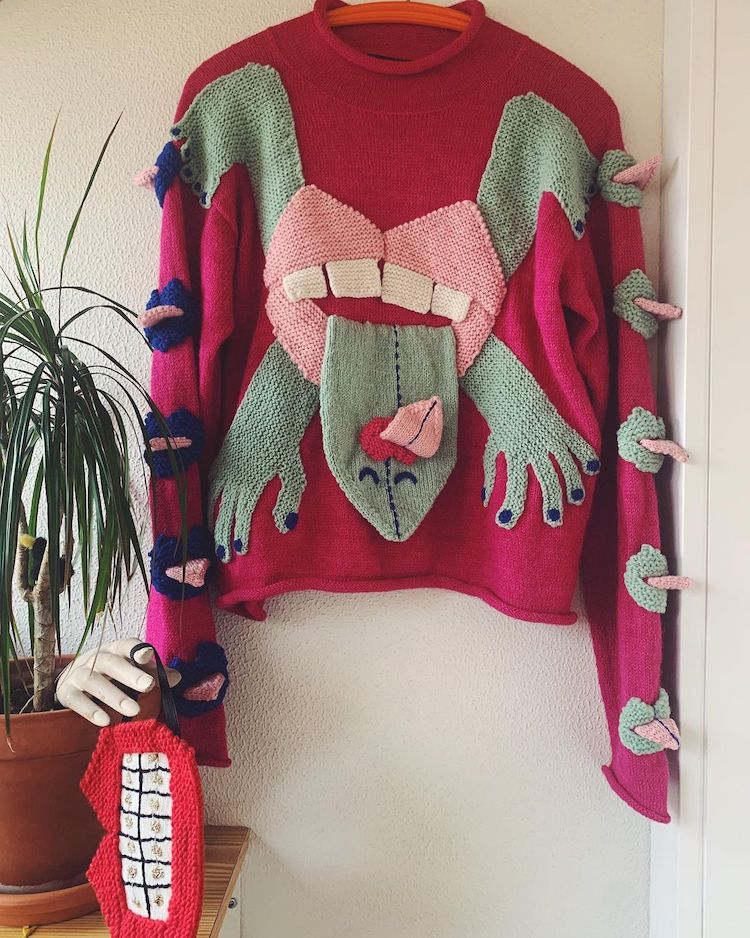 Knitted sweater with eyes and mouth on it by Ýrúrarí
