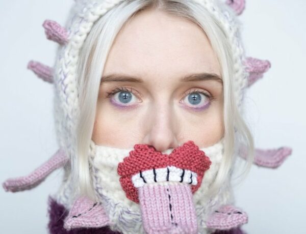 Knitted sweater with eyes and mouth on it by Ýrúrarí